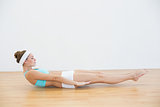 Attractive sporty woman doing sports exercise lying on the floor