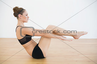 Profile view of beautiful woman doing a sports exercise