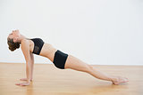 Slender woman doing yoga pose