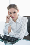Thoughtful businesswoman sitting at her desk