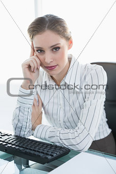 Thoughtful businesswoman sitting at her desk