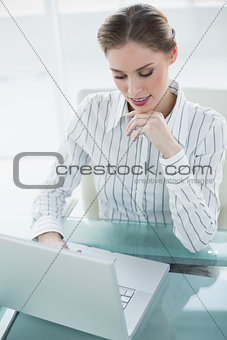 Gorgeous calm businesswoman working with her notebook