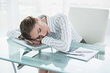 Tired young businesswoman sleeping in her office
