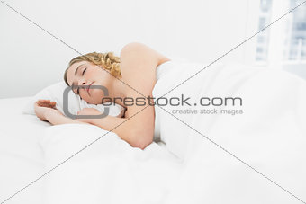 Pretty calm blonde lying in bed napping