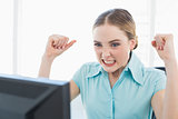 Classy angry businesswoman sitting in front of computer