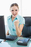 Classy successful businesswoman sitting in front of computer