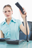 Classy angry businesswoman hanging up phone