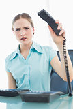 Classy furious businesswoman hanging up phone