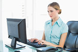 Classy calm businesswoman working at computer