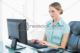 Classy calm businesswoman working at computer