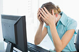 Classy frustrated businesswoman working at computer