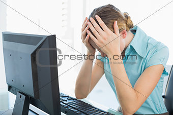 Classy frustrated businesswoman working at computer