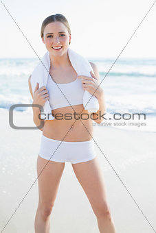 Cheerful slender woman holding white towel