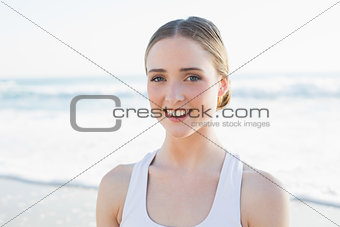 Content young brunette woman sitting on the beach