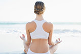 Rear view of calm young woman meditating