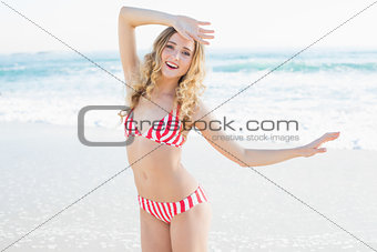 Enjoying young woman dancing on the beach