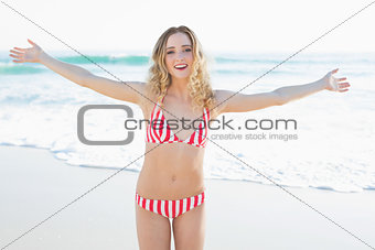 Attractive blonde woman spreading her arms