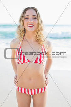 Happy blonde woman posing on the beach