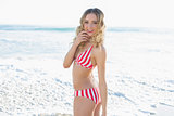 Happy blonde young woman wearing a red bikini