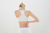 Slender sporty woman touching her injured nape