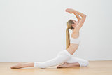 Attractive fit woman doing yoga pose in sports hall
