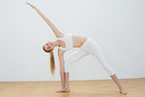 Fit young woman stretching her body in yoga pose