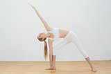Happy toned woman stretching body with yoga pose