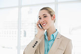 Beautiful chic businesswoman phoning with her smartphone