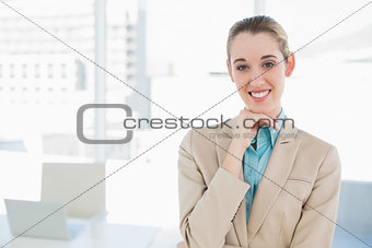 Beautiful chic businesswoman posing touching her chin