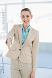 Chic businesswoman reaching her hand smiling friendly at camera