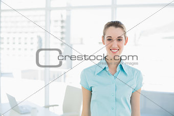 Beautiful young businesswoman posing in her office
