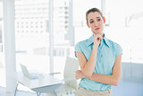 Lovely thoughtful businesswoman posing in her office