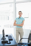 Attractive peaceful businesswoman posing with arms crossed