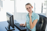 Peaceful thinking businesswoman working on her computer