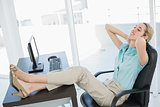 Classy young businesswoman relaxing sitting on her swivel chair