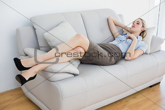 Calm businesswoman lying on couch