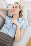 Beautiful calm businesswoman sleeping lying on her couch
