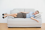 Attractive peaceful businesswoman sleeping lying on couch