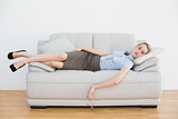 Calm chic businesswoman sleeping while lying on her couch