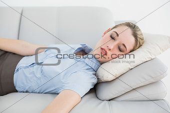 Cute classy businesswoman sleeping on her couch