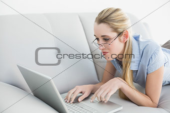 Serious peaceful businesswoman working on laptop