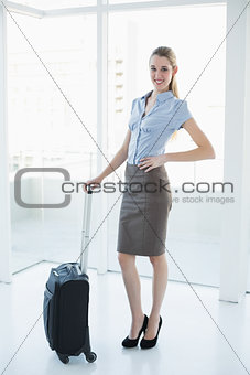 Content lovely businesswoman posing standing in office