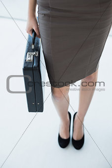 Classy businesswoman holding a black briefcase
