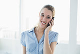 Attractive blonde businesswoman phoning with her smartphone