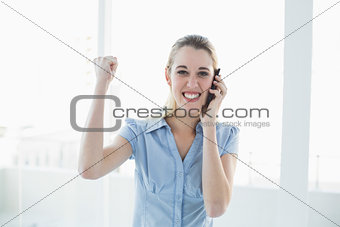 Beautiful happy businesswoman phoning with her smartphone