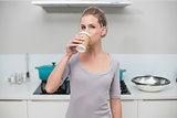 Calm gorgeous blonde drinking from disposable cup