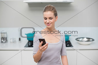 Smiling gorgeous model holding smartphone