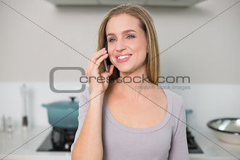 Cheerful gorgeous model phoning looking away