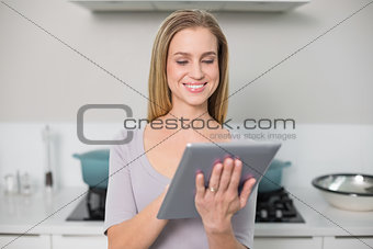 Cheerful gorgeous model using tablet