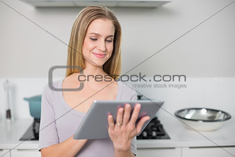 Smiling gorgeous model using tablet